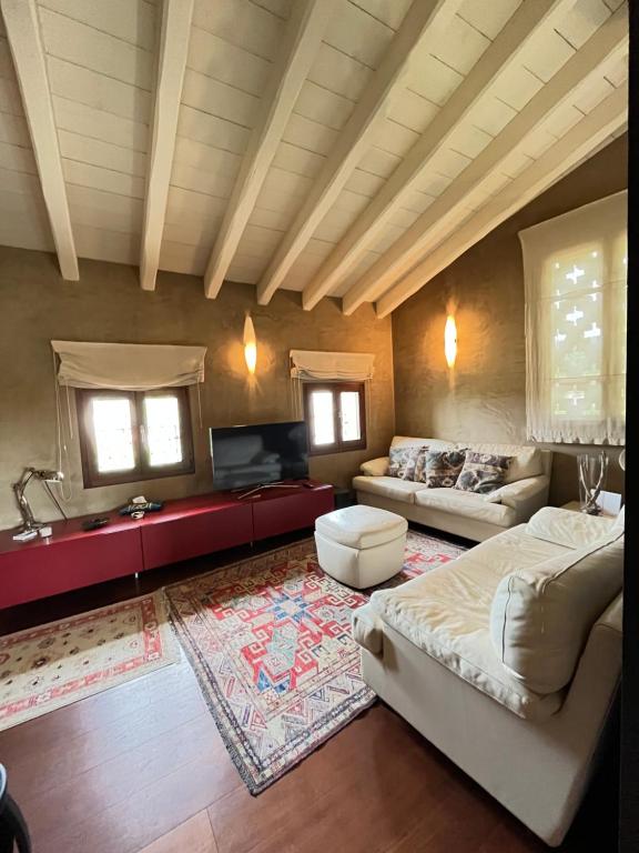 ein großes Wohnzimmer mit einem Sofa und einem Tisch in der Unterkunft Luxuryloft La Guarnigione in Valeggio sul Mincio