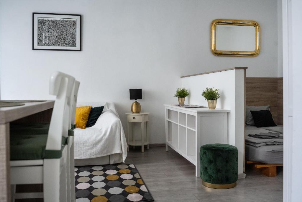 a small bedroom with a bed and a mirror at Dohány Street Delight in Budapest