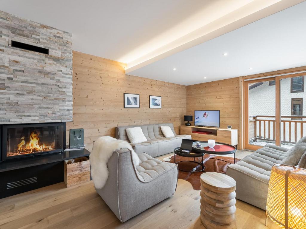 a living room with a couch and a fireplace at Appartement Saint-Martin-de-Belleville, 5 pièces, 8 personnes - FR-1-570-26 in Levassaix