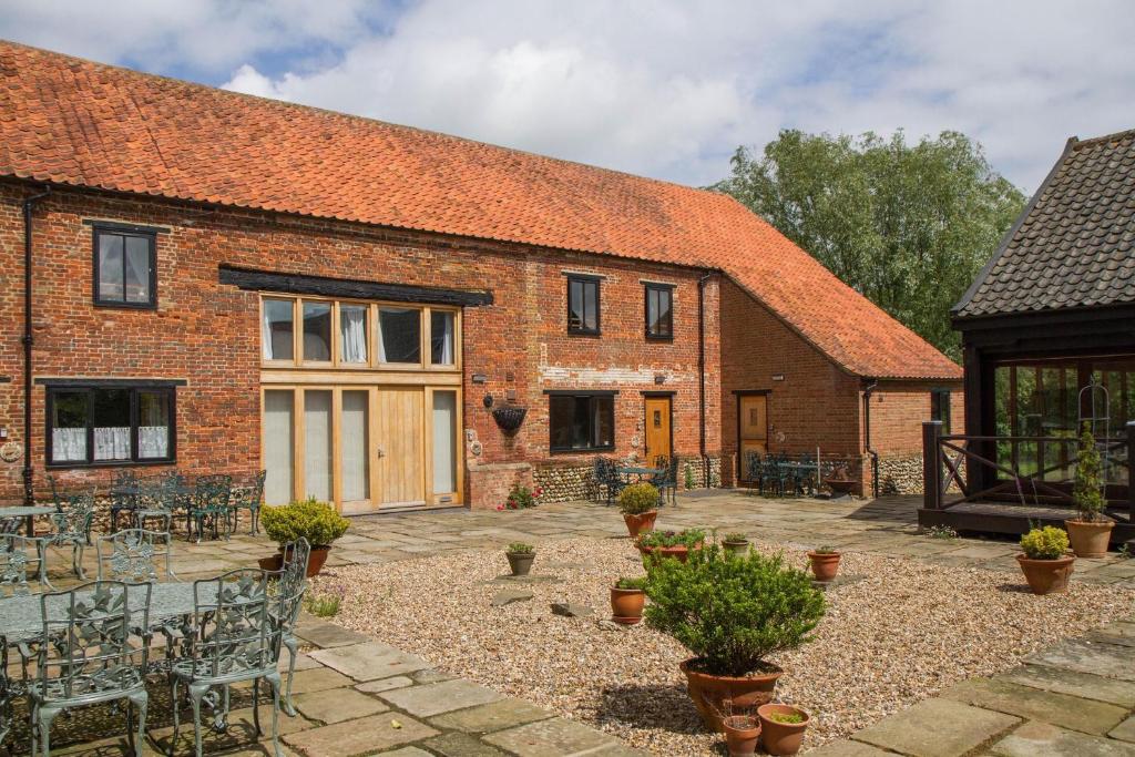 an external view of a brick building with a patio at Great Barn in Colkirk