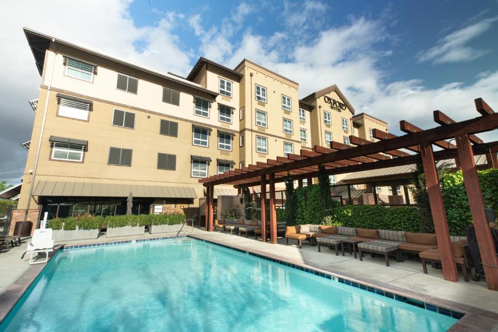 a swimming pool in front of a building at Oxford Suites Paso Robles in Paso Robles