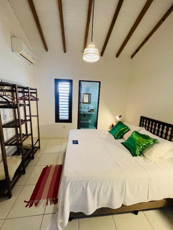 Uma cama ou camas num quarto em Pousada Pandoro