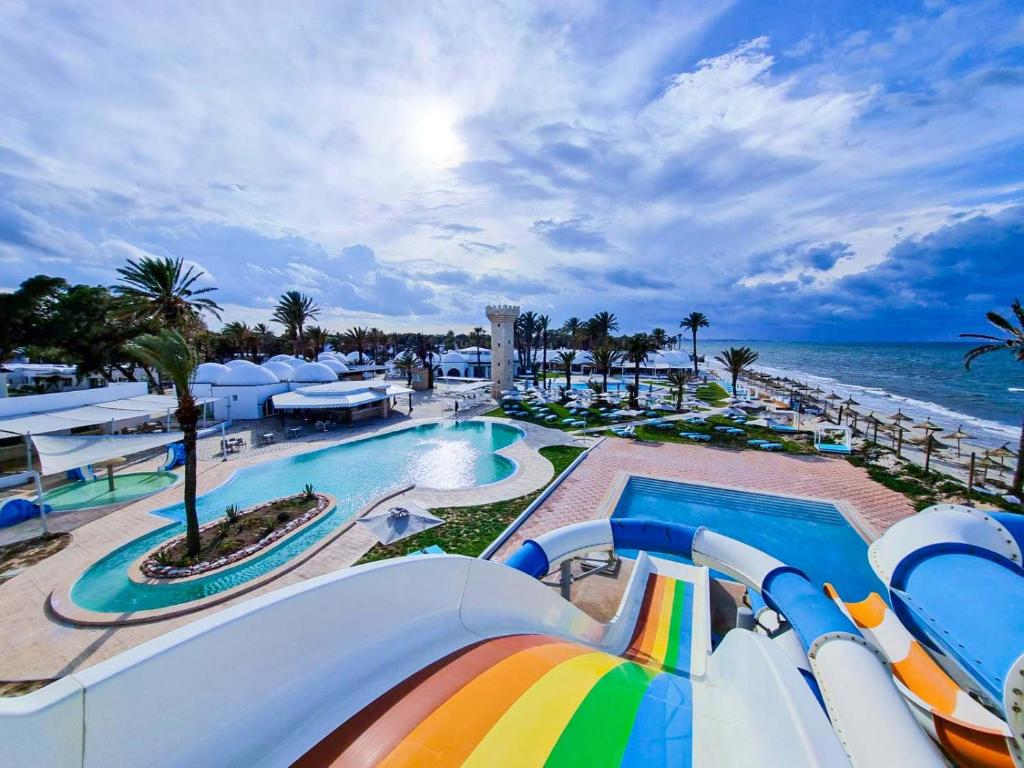 a resort with a pool and a water slide at Monarque Club Rivage - VV in Monastir