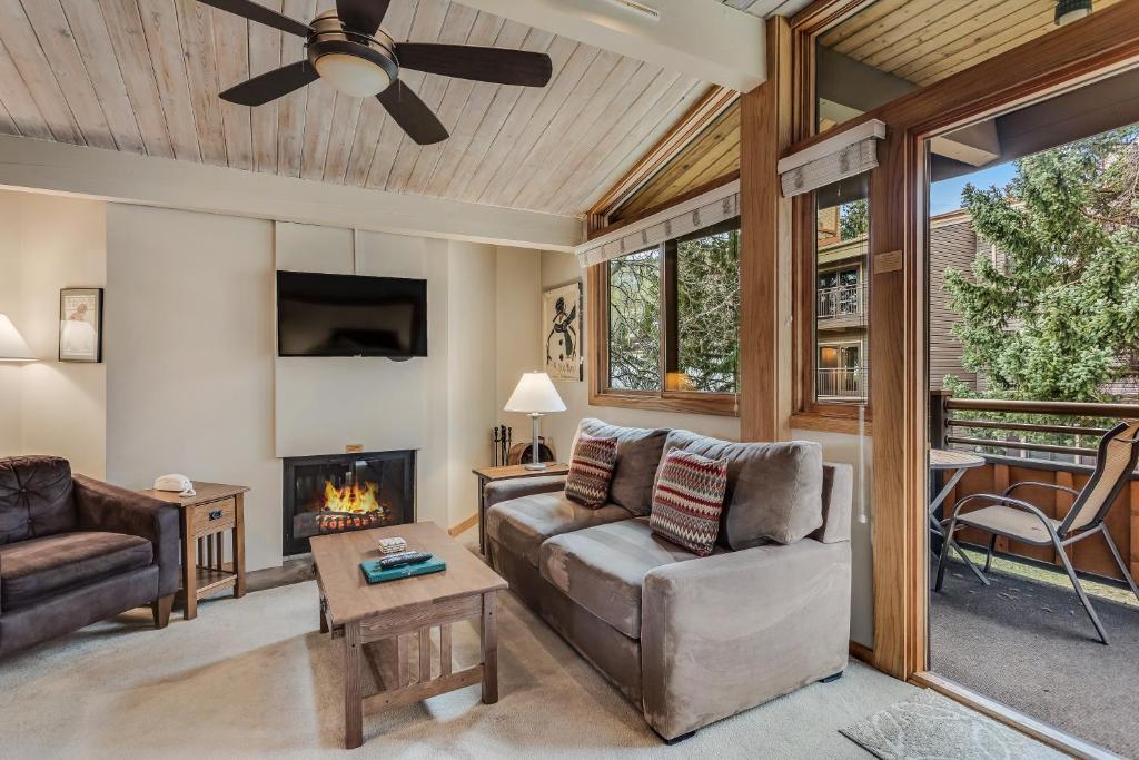 a living room with a couch and a fireplace at Laurelwood Condominiums 412 in Snowmass Village