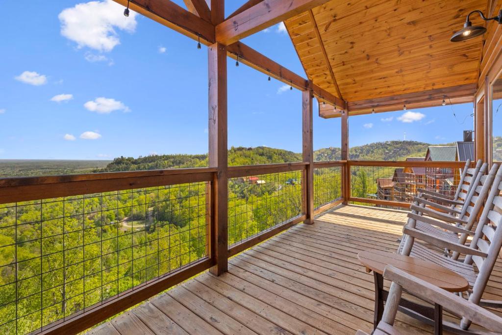 a porch with two chairs and a view of the mountains at Dolly Valley View in Sevierville