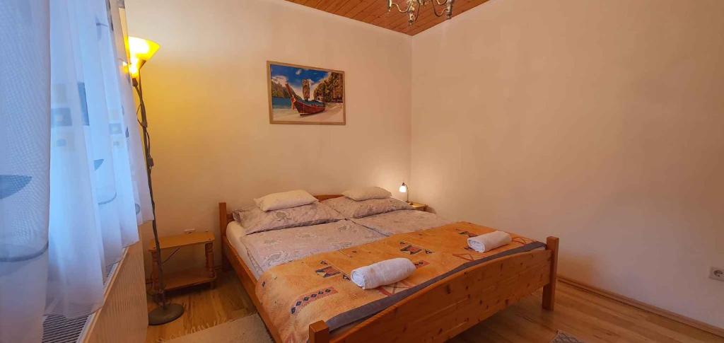 a bedroom with a bed with two pillows on it at Holiday home in Keszthely/Balaton 39648 in Keszthely