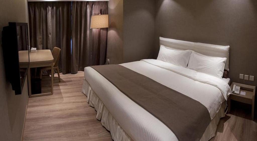 Postel nebo postele na pokoji v ubytování Inn Hotel Macau