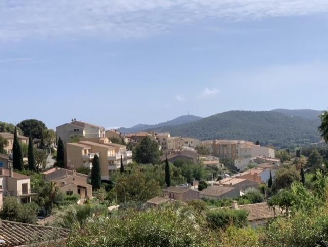 a view of a town with houses and trees at small house 6p in bormes, quiet , hill-view in Bormes-les-Mimosas