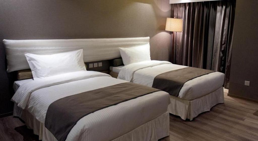 Postel nebo postele na pokoji v ubytování Inn Hotel Macau