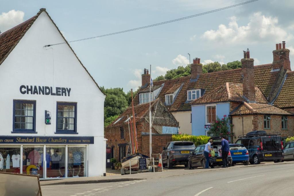 a street in a small town with houses at Harbour View Cottage in Wells next the Sea