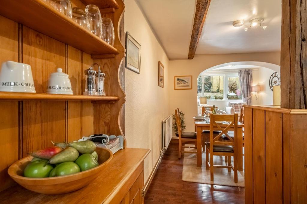 a kitchen with a bowl of fruit on a counter at Harbour View Cottage in Wells next the Sea