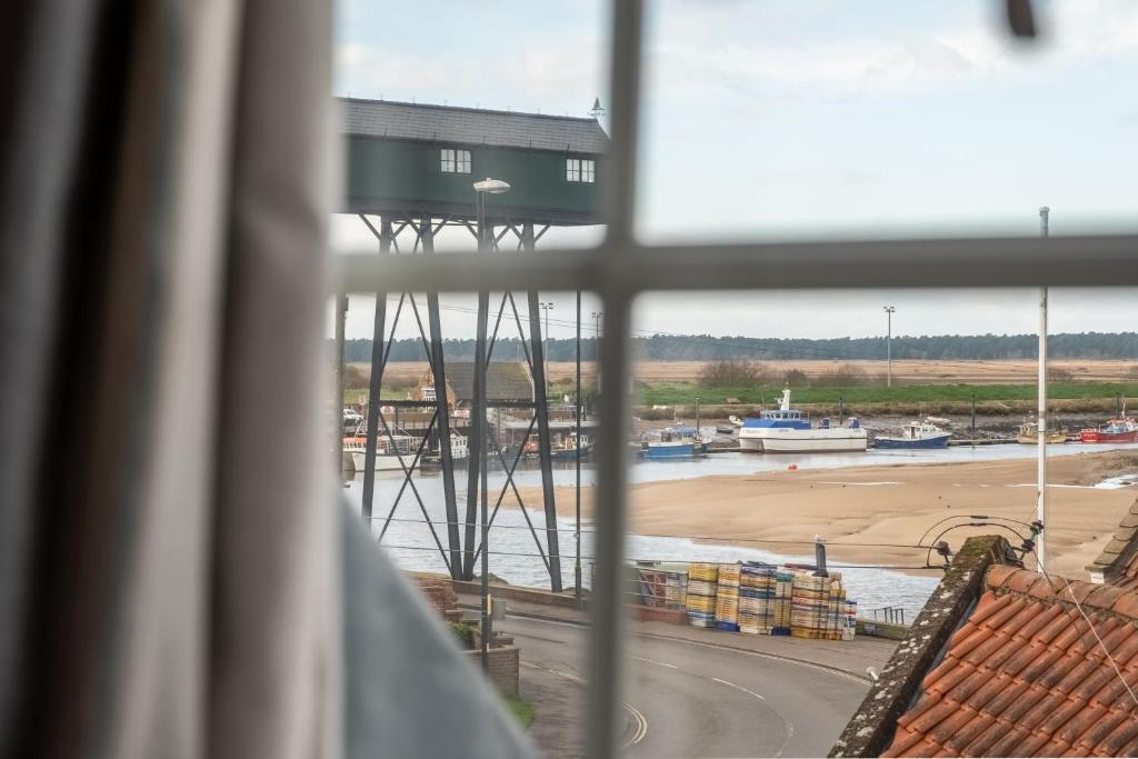 a view of a harbor from a window at Harbour View Cottage in Wells next the Sea