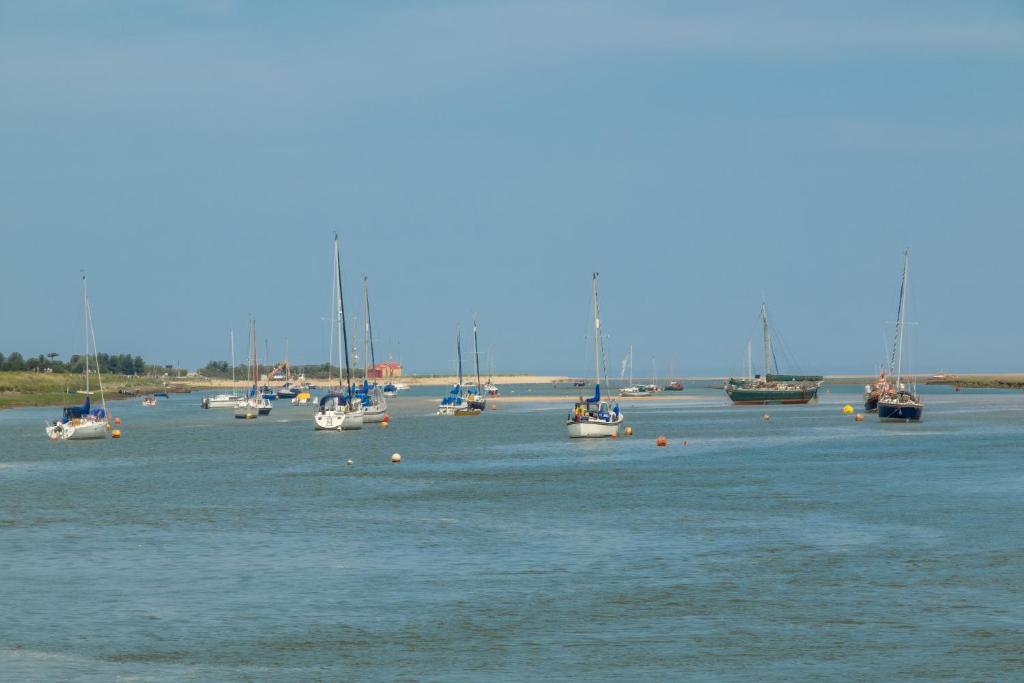 a group of boats sitting in the water at Harbour View Cottage in Wells next the Sea