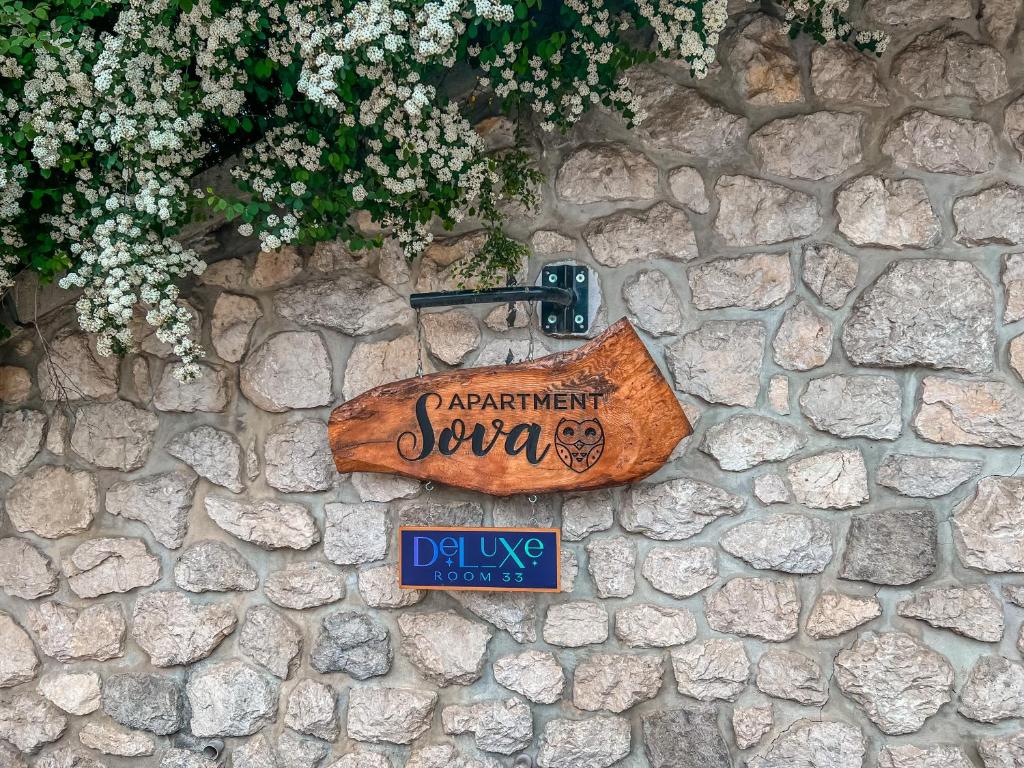 a sign on the side of a stone wall at Deluxe Room 33 in Bled