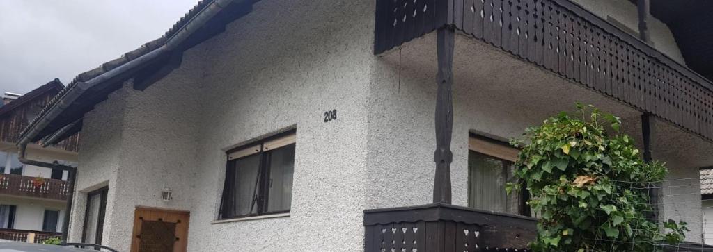 a building with a plant on the side of it at Apartma Sabatuš in Bohinj