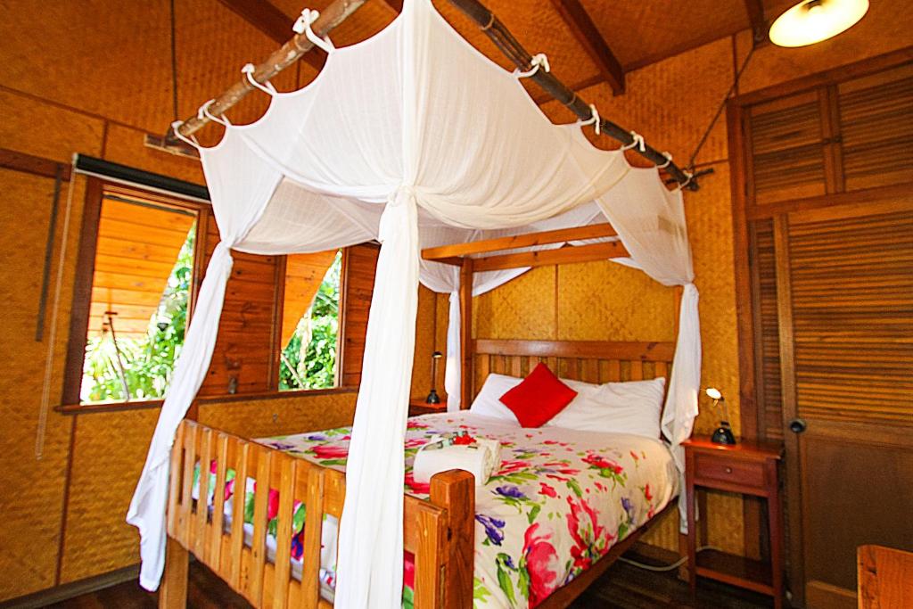 a bed that has a canopy over it at 1770 Beach Shacks in Seventeen Seventy