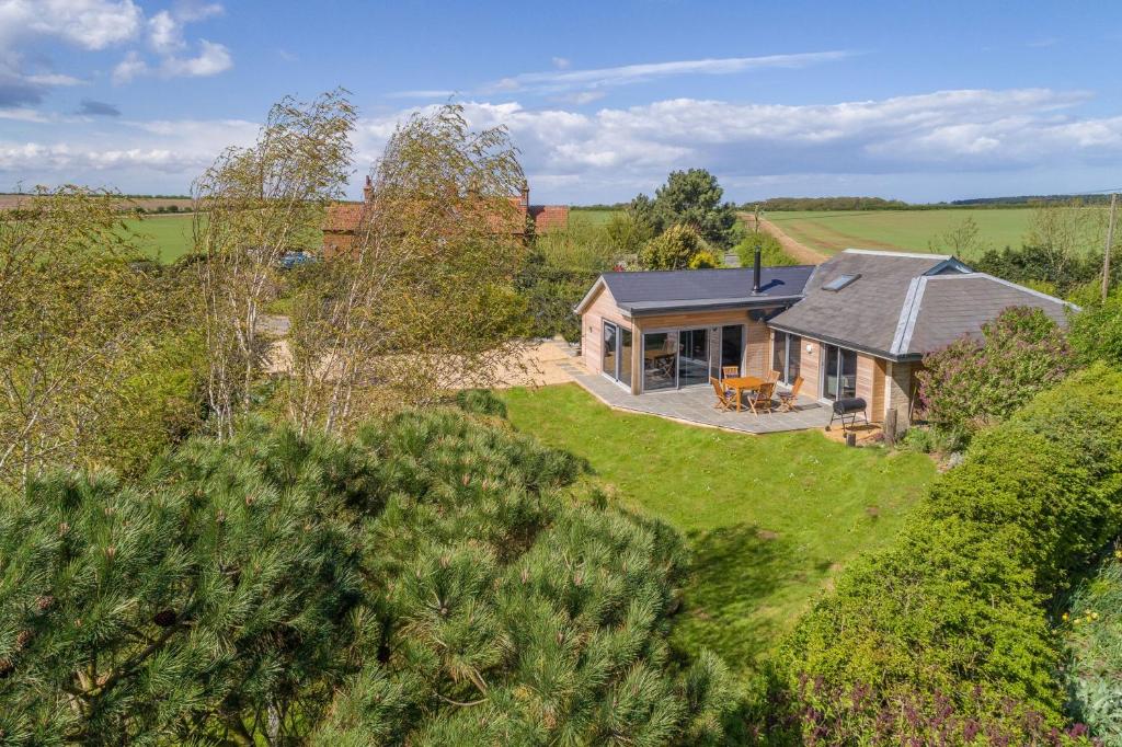 an aerial view of a house in the countryside at Peterstone Lodge in Holkham