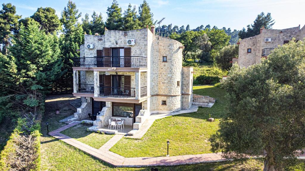 an old stone house in the middle of a forest at Twin Castles Maisonettes by RentalsPro - Kriopigi Halkidiki in Kriopigi