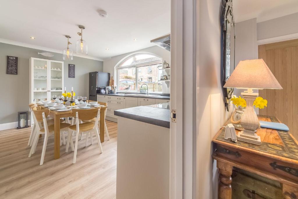 a kitchen and dining room with a dining table at Kipling House 8 in Wells next the Sea