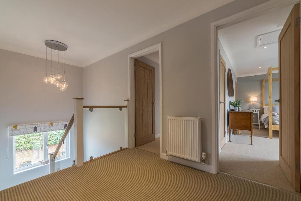a hallway of a home with a staircase and a door at Kipling House 8 in Wells next the Sea