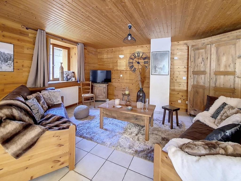 a living room with a couch and a table at Chalet Saint-Martin-de-Belleville, 4 pièces, 8 personnes - FR-1-344-738 in Saint-Marcel