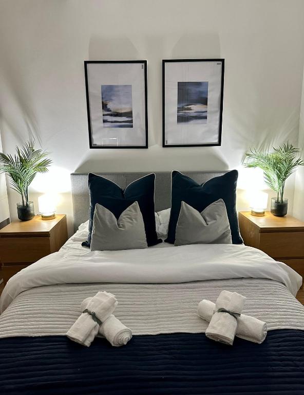 a bedroom with a bed with two towels on it at Retreat to a Stylish Ensuite in London in London