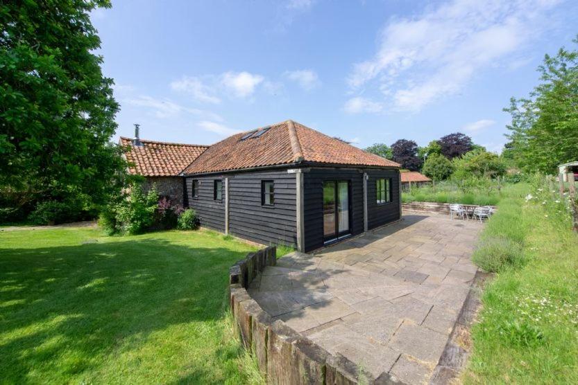 a small cabin in the yard of a house at Apple Tree Barn in Langham