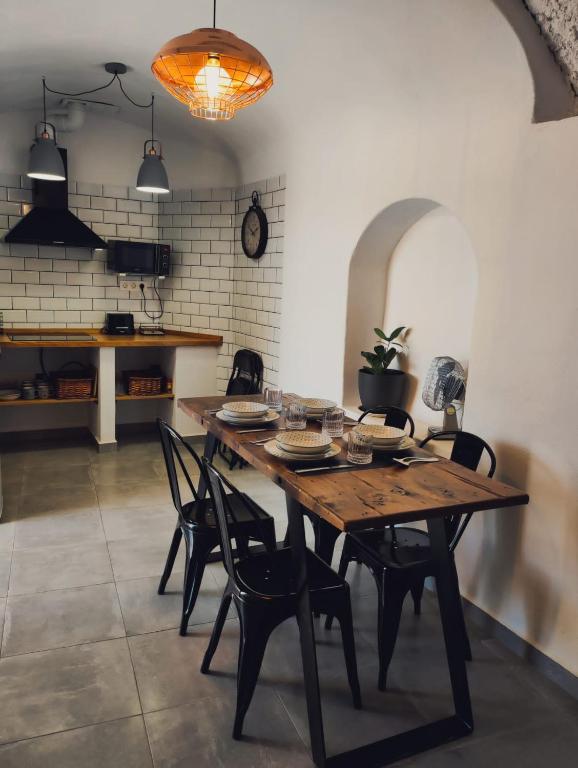 a dining room with a wooden table and chairs at La Madriguera Eco Caves 3 in Guadix