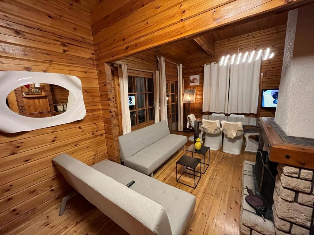 uma sala de estar com um sofá e uma televisão numa cabina em Chalet Cosy JMV em Les Angles