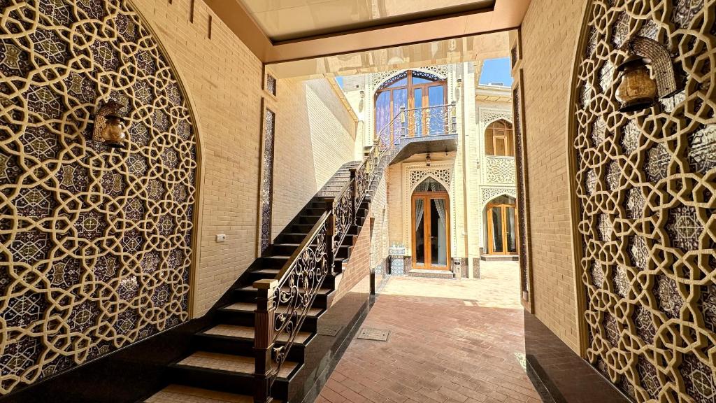 a hallway of a building with a staircase and a door at Boutique Hotel Mosaic in Samarkand