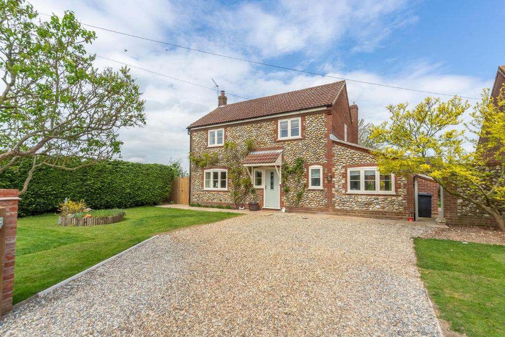 a brick house with a gravel driveway at Stone Croft in Barney