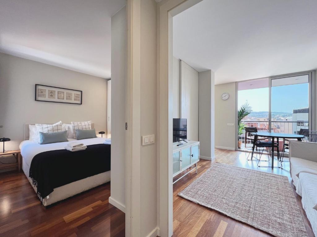 バルセロナにあるStay U-nique Apartments Sants IIのベッドルーム1室(ベッド1台付)、リビングルームが備わります。