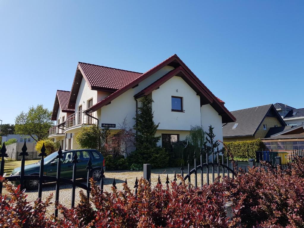 a house with a car parked in front of it at VILLA POMERANIA in Rowy