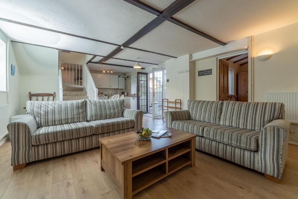 a living room with two couches and a coffee table at Crabpot Cottage in West Runton