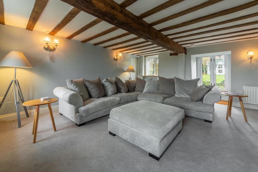 a living room with a couch and a table at Barn Cottage 6 in Salthouse