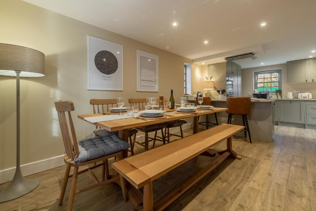 a kitchen and dining room with a table and chairs at Foxhill House in South Creake