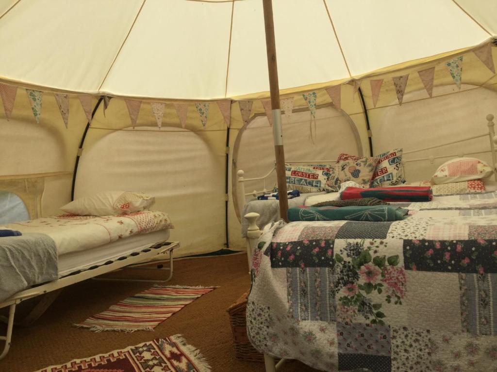 a bedroom with two beds in a tent at Horsemans Stargazing Tent in Kingsbridge