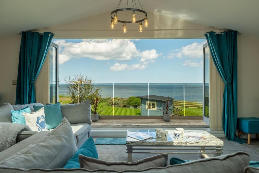a living room with a view of the ocean at Sunset in Overstrand