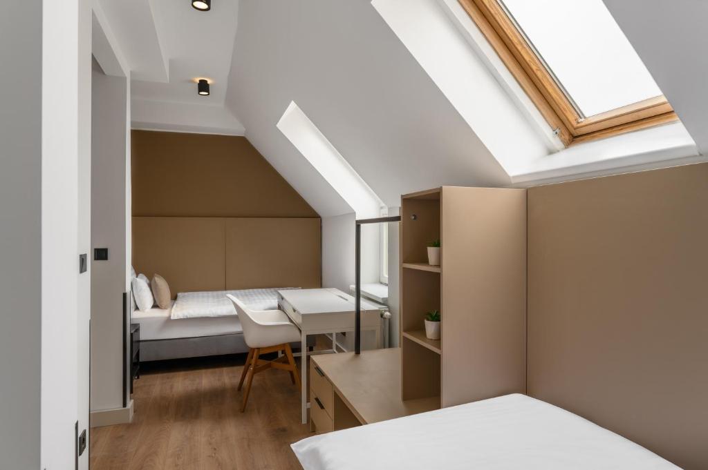 a bedroom with a bed and a desk and a window at Florin Apart Hotel in Budapest