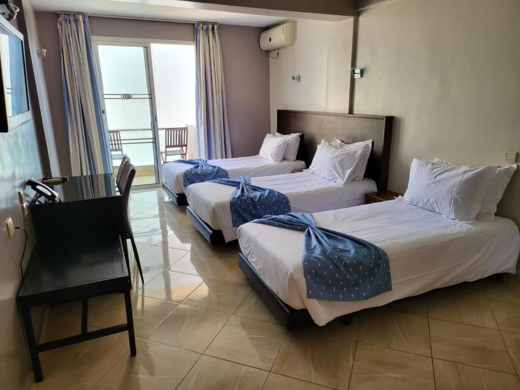 Postel nebo postele na pokoji v ubytování Résidence Hotelière Fleurie