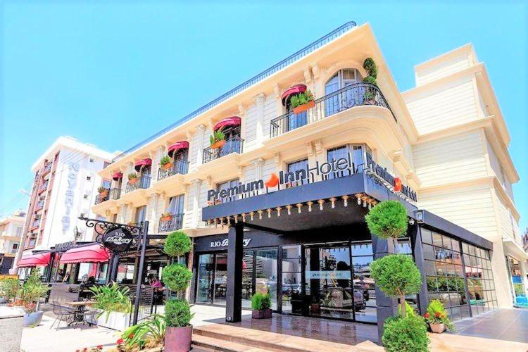 ein großes Gebäude mit Balkonen und Pflanzen darauf in der Unterkunft PREMIUM INN City Hotel & Restaurant Central Shopping Street Location ! in Famagusta