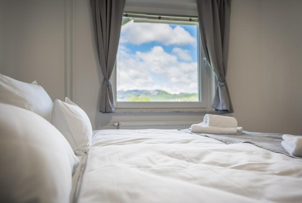 a white bed in a room with a window at Apartma Lida 1 in Bled