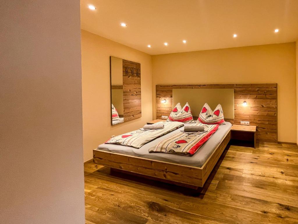 - une chambre avec un lit et un miroir dans l'établissement Apartment Waldnah, à Wenns