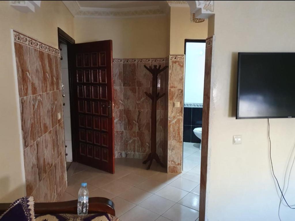 ein Wohnzimmer mit 2 Türen und einem TV in der Unterkunft Agadir in Agadir