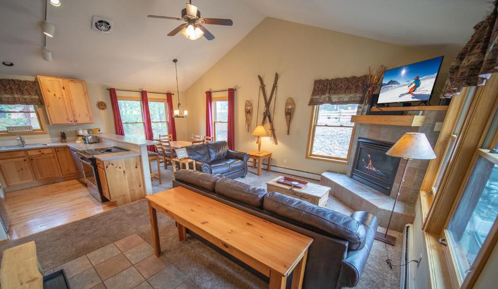 a living room with a couch and a fireplace at Snake River 26 in Keystone