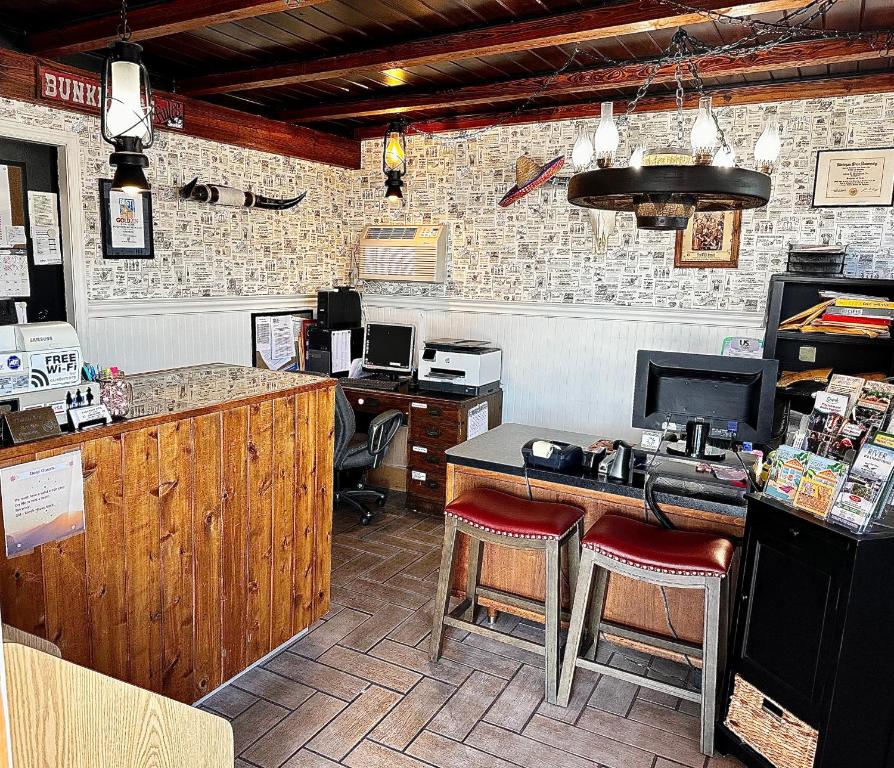 a restaurant with a counter and a bar with stools at Buffalo Chip's Ranch House Motel in Bonita Springs