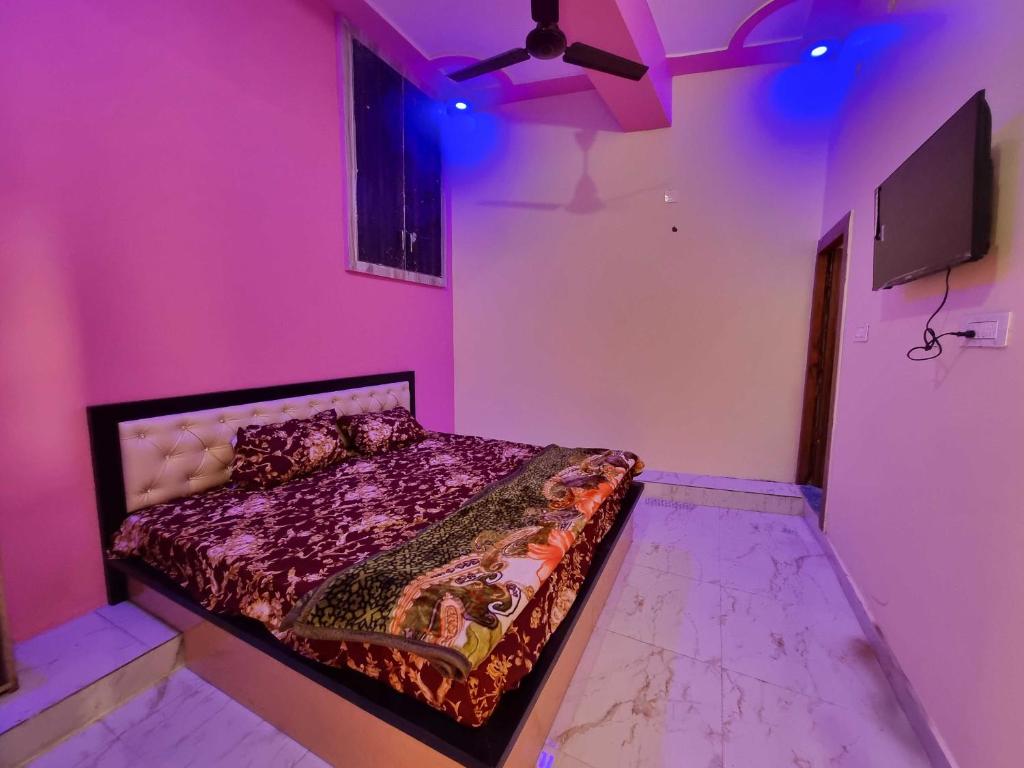 ein Schlafzimmer mit einem Bett in einem rosa Zimmer in der Unterkunft OYO Hotel Raj Residency in Aligarh