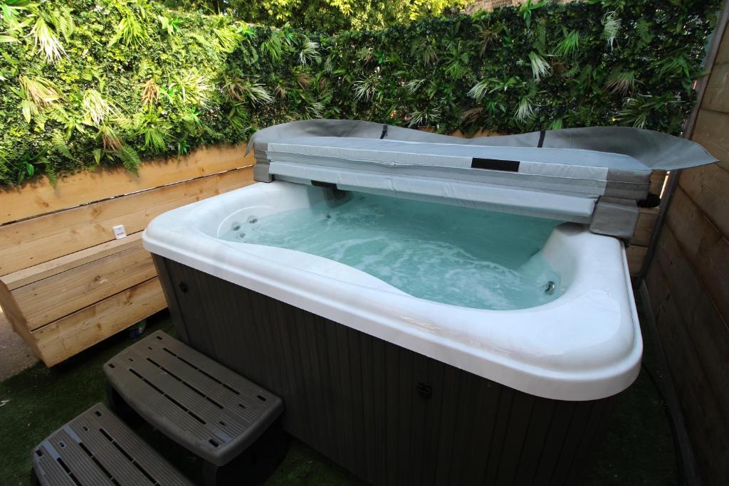 a bath tub with a toilet in it at The Old Schoolhouse in Whitstable