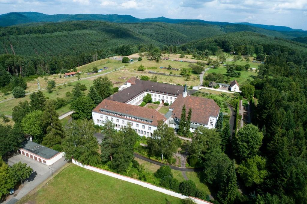 an aerial view of a building in the middle of a field at Kloster Esthal in Esthal