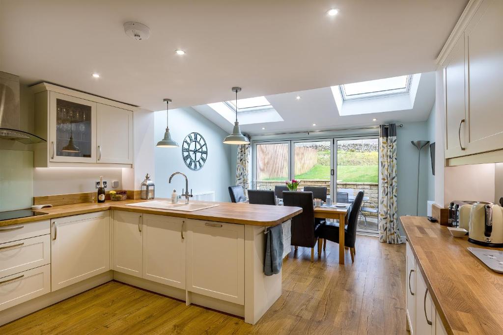 a kitchen with a table and a dining room at Burbage View in Buxton